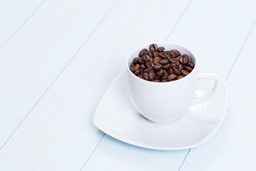 Coffee cup with coffee beans on table