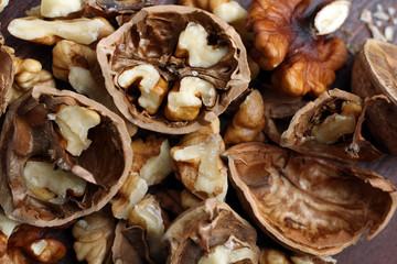 walnuts are broken on a brown wooden table