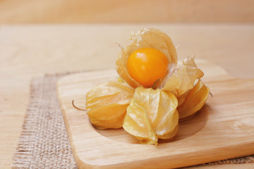 Cape gooseberry (Physalis) on wooden plate