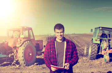 Farmer with tractors in the field