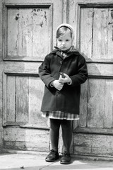 Photo in retro style. Cute little girl in a kerchief.