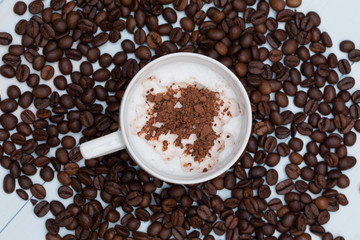 Cup of cappuccino coffee with beans