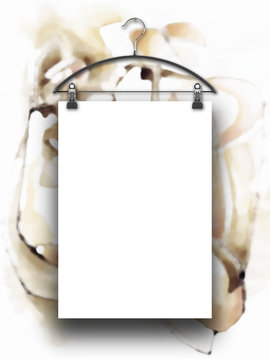 Close-up of one hanged paper sheet with clothes hanger on out of focus brown abstract painting background