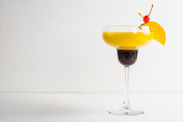 Orange cocktail on the wooden background