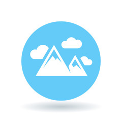Mountain range icon. Mountains symbol. Mountain peak sign. White mountains with clouds icon on blue circle background. Vector illustration.