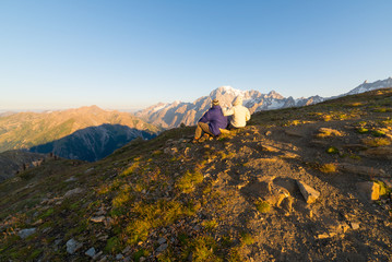 Couple watching sunrise over Mont Blanc summit