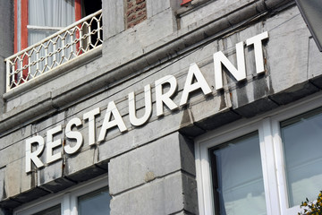 Fototapeta na wymiar The word Restaurant at facade of old building in Wallonia, Belgium