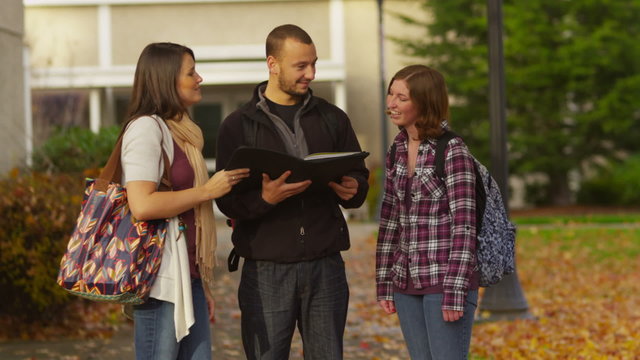 Three college students talking together on campus