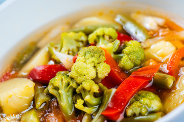Vegetable soup made of red pepper, broccoli, potatoes and carrots