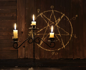 Candelabrum against background with pentagram