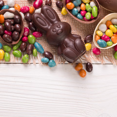 Chocolate Easter eggs and rabbit , on wooden background