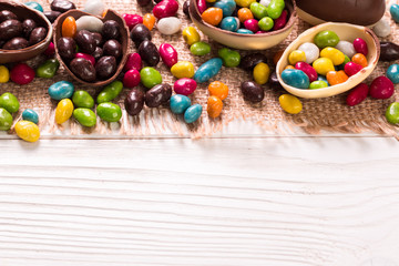 Chocolate Easter eggs and rabbit , on wooden background