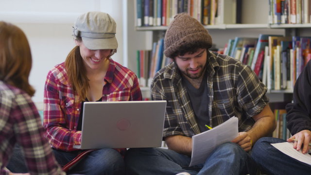 Group of college students studying in library