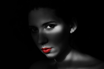 Artistic beauty portrait of young woman with creative lighting