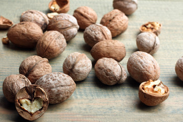 walnuts are broken on a brown wooden table
