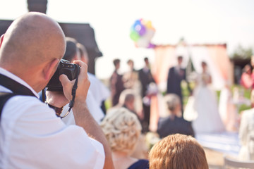 Photographer photographing a wedding ceremony