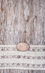 Vintage background with lace on the old wood