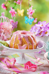easter ring cake with pink icing and butterfly shaped sugar spri