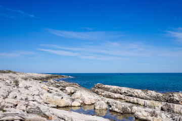 Rocky shoreline near Polignano a Mare in a sunny day. Apulia, Italy.