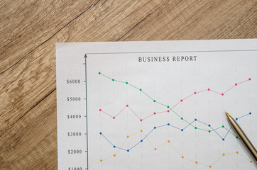 business report with pen on desk