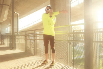 Stretching after jogging on a bridge.