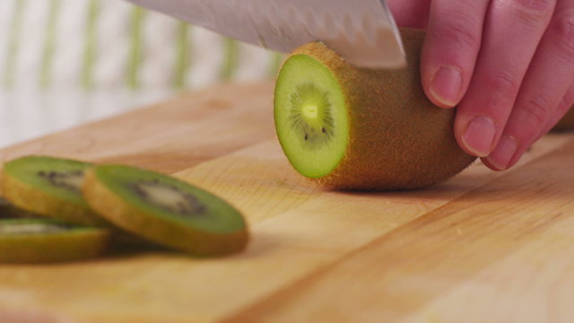Cutting kiwi fruit, closeup