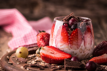Breakfast parfait with homemade granola and yogurt on wooden table , healthy food