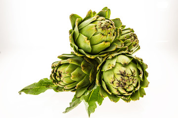 Fototapeta premium Three fresh artichokes, isolated on white background.