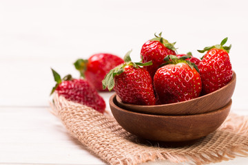 Ripe red strawberries on wooden table, healthy food
