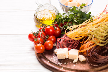  Vegetable color Pasta, oil,tomatoes,cheese on wooden table. italian food