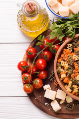  Vegetable color Pasta, oil,tomatoes,cheese on wooden table. italian food