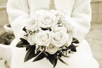 Bride with bouquet, closeup. Sepia