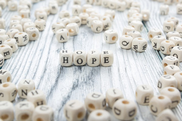 Hope word written on wood block. Wooden ABC.