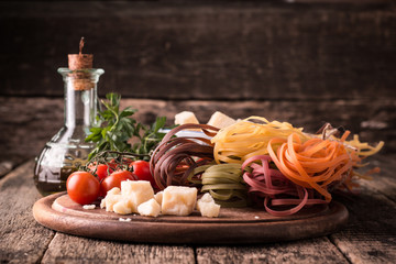  Vegetable color Pasta, oil,tomatoes,cheese on wooden table. italian food