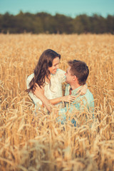 Young couple in love outdoor.Stunning sensual outdoor portrait of young stylish fashion couple posing in summer in field