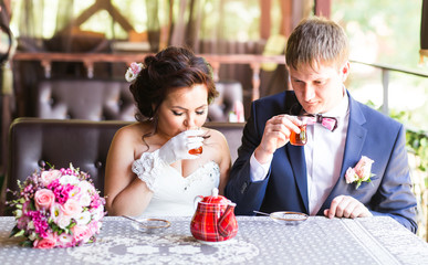 Groom and bride are drinking tea.
