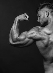 Strong Athletic Man Fitness Model posing back muscles, triceps,