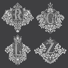 Set of ornamental monogram in coats of arms form. White floral decorations on black. Isolated tattoos in vintage baroque style.