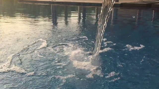 slow motion water drop on a pool