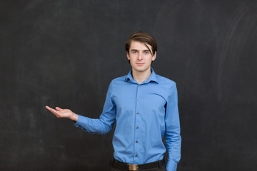 Portrait of a business man standing next to a blackboard.