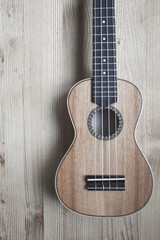 Fototapeta premium ukulele on wooden background. close up
