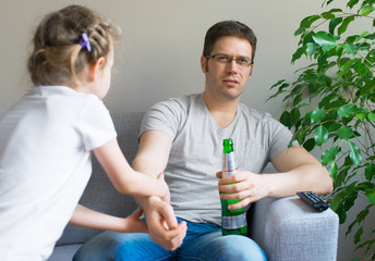 Little girl calling dad to play while he watching TV.