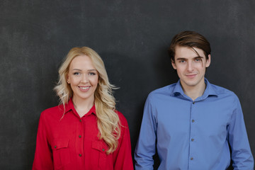 Business couple on chalkboard background