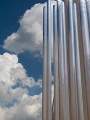 Vertical Group of Steel Metallic Pipe and Blue Sky in Background