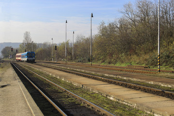 Train in the distance on the track arrives at station