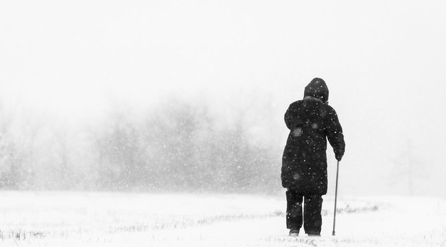 Old Woman In Snow Blizzard