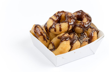 Packaging of donuts with chocolate sauce isolated on white backg