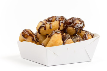 Packaging of donuts with chocolate sauce isolated on white backg