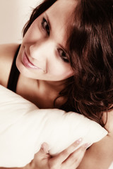 Obraz premium Sexy girl lazy woman with pillow on bed in bedroom