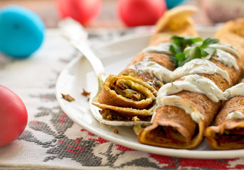 Easter eggs and pancake rolls with mushrooms